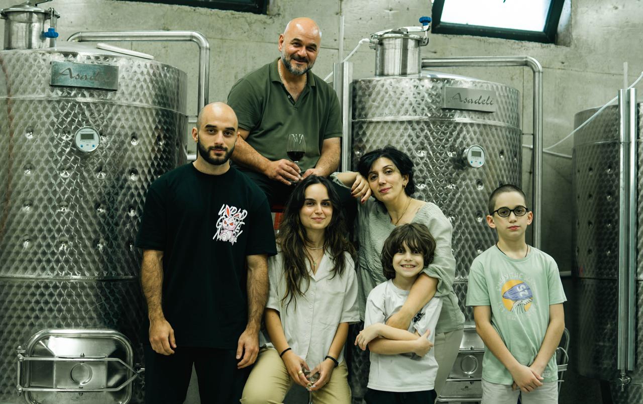 The whole Asadeli family in front of the cellar tanks